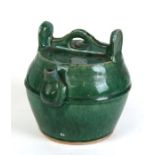 A 19th century Chinese Shiwan green glazed wine pot, 22cms (8.75ins) high.