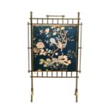 A Victorian Aesthetic Movement brass and textile fire screen, 62cms (24.5ins) wide.