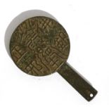 An antique Chinese bronze mirror with concave surface and decorated with calligraphy to the
