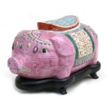 A large Chinese famille rose jar and cover in the form of a pig on a hardwood stand, 43cms (17ins)