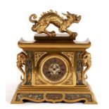 A 19th century gilded bronze mantle clock, the dial with Roman numerals, the case with inset mixed