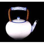 A large 20th century Meissen white glazed teapot, highlighted to the spout and floral knop in