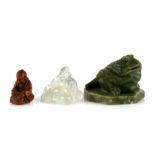 A Chinese carved rock crystal Buddha, 4cms (1.5ins) high; together with a green hardstone carving in