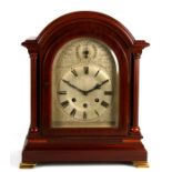 An early 20th century three-train bracket clock, the silvered dial with Roman numerals, in a