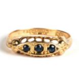 An 18ct gold and sapphire three stone ring, Birmingham 1918, 1.8g. Approx. UK size K.