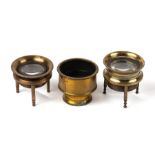 A 19th century lacquered brass tripod map reading lens; together with another similar and a