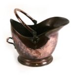 A large copper helmet shaped coal scuttle, together with another