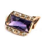 A 9ct gold ring set with a rectangular amethyst flanked by diamonds, approx UK size 'K'.