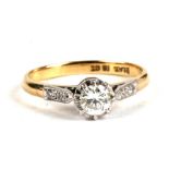 An 18ct gold, platinum and diamond ring, the central stone approximately 0.3cts, flanked to the