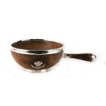 A Victorian turned walnut bowl with single carrying handle and silver plated mounts, having an