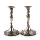 A pair of late 18th century continental, possibly Italian, white metal candlesticks, unmarked but
