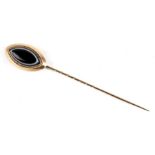 A 19th century 15ct gold (tested) mourning stick pin, set to the head with an oval of black and