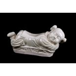 A Chinese crackle glaze neck rest in the form of a sleeping child, 31cms (12.25ins) wide.Condition
