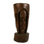 A large South American carved rosewood mortar and pestle, 76cms (30ins) high.