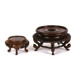 A Chinese hardwood five-legged vase stand, 17cms (6.75ins) diameter; together with a similar