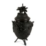 A Japanese Meiji period bronze koro highly decorated with chrysanthemums, on three bamboo style