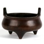 A Chinese bronze two-handled censer with six character mark to the underside, 11.5cms (4.5ins)
