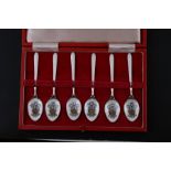 A cased set of six silver and enamel coffee spoons with Prince of Wales feathers crest to the bowls,