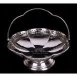A George V pierced silver fruit basket of circular lobed form with swing handle. Birmingham 1928.