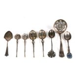 A quantity of silver spoons including a sugar sifter.