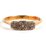 An 18ct gold three stone diamond ring. Approx. UK size P