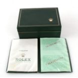 A vintage green Rolex watch box with Rolex Guarantee wallet.