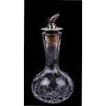 A cut glass and silver oil bottle with leaping salmon pourer, Birmingham 1975, 13cms (5ins) high.