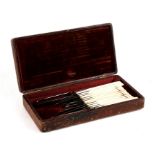 An early 19th century leather cased surgeon's kit containing twelve implements including scalpel and