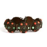 A Chinese seven panel bracelet, each set with central jade cabochon within a border of turquoise and