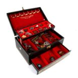 A quantity of costume jewellery to include brooches and pendants in a black jewellery box.