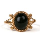 A 9ct gold dress ring set with an oval blue black cabochon, approx UK size 'N'.