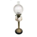 A Victorian oil lamp with etched glass shade and cut glass reservoir, on a brass Corinthian