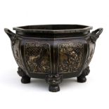 A large Chinese two handled bronze octagonal planter, decorated figures within panels and standing