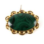 A Victorian gilt metal and malachite brooch, 6cms (2.25ins) wide.