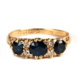 An Edwardian 18ct gold diamond and sapphire ring set with three sapphires and four diamonds,