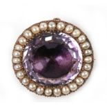 A large gold brooch, the central amethyst surrounded by pearls. 32mm, stone 24mmCondition