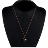 A 9ct gold oval pendant set with a large bloodstone cabochon with a yellow metal chain. Pendant 8.