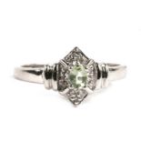 A 9ct white gold Art Deco style diamond and peridot ring, 2.5g. Approx. UK size N.