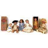 A group of bisque headed, composite and early plastic dolls.