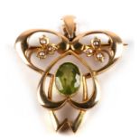 An Art Nouveau 15ct gold pendant brooch set with pearls and central green peridot, 6g. 3.5cms (1.