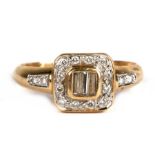 An 18ct gold diamond ring set with three central baguette diamonds surrounded by diamonds, with