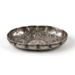 A white metal oval dish with central dragon and double headed eagle decoration. 16.5cm (6.5ins)