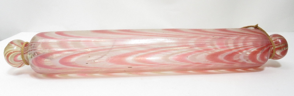 A Victorian Nailsea glass rolling pin, clear glass with pink and white detail, 43cms long