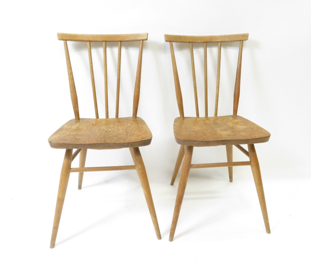 A pair of Ercol light wood stick back chairs