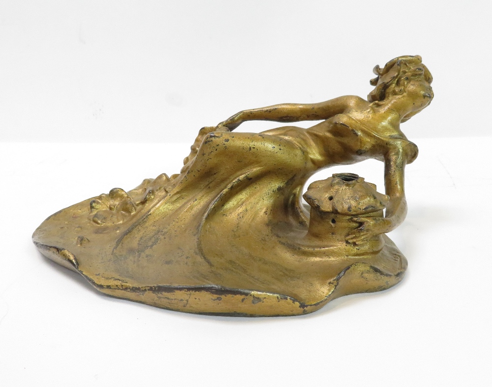 An Art Nouveau French gilt metal desk stand modelled as a young woman in flowing dress with flowers,