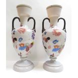 A pair of Edwardian pink painted glass two handled vases, decorated with flowers and plants, 35cm