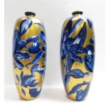 A pair of 20th century Phoenix Ware vases, with blue and white flowers on a gold background, 23cm