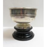 A small silver pedestal trophy bowl, unengraved, on wood base, approximately 3oz troy