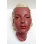 A Goldscheider mask, modelled as a female with blonde hair, with black backstamp 22cm high