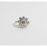 A nine stone diamond ring 18 carat gold cluster ring, the central brilliant cut, calculated as